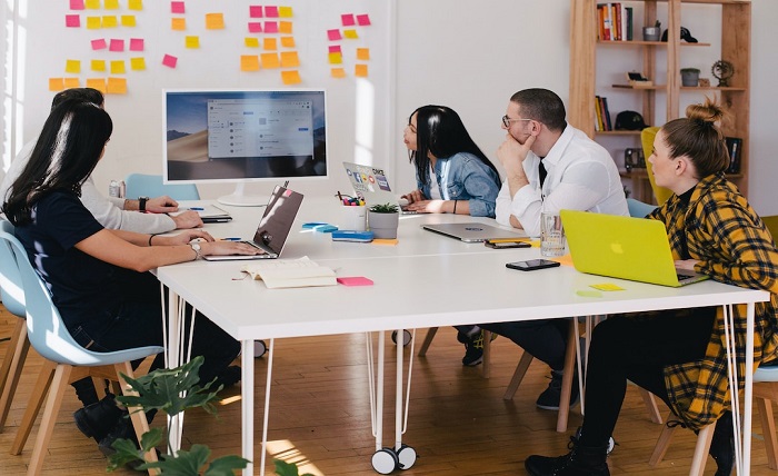 Strategies for Utilizing Technology in Project Accounting A team in an office discussing project accounting during a meeting