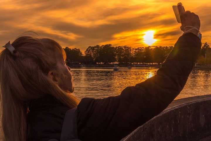 Embracing the Twilight Hours: 100 Captions for Your Evening Instagram Posts adult woman taking a selfie in the evening with the royalty free image 1683751384